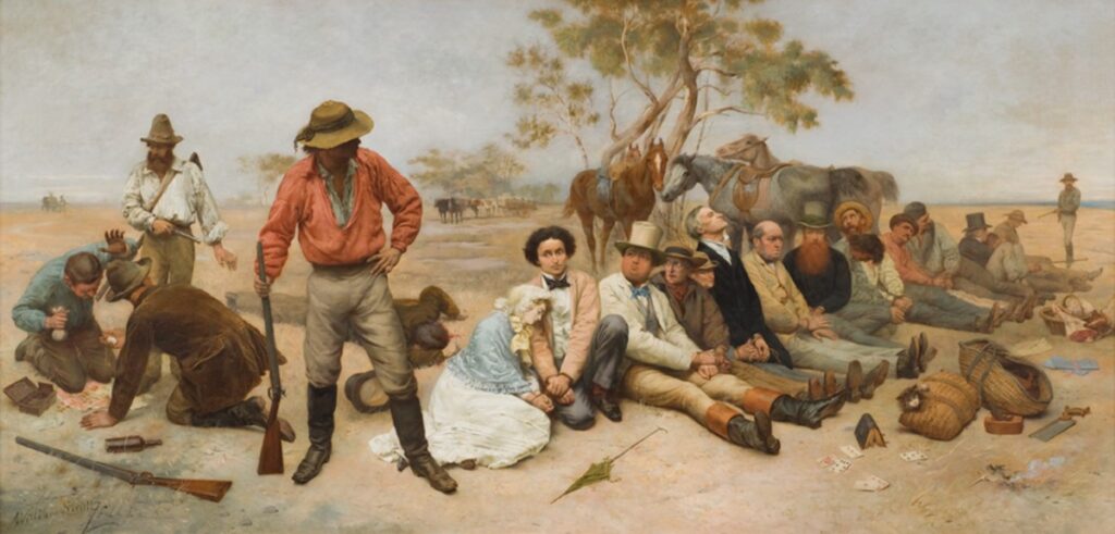 A painting of bushrangers robbing and holding hostage a group of people in Victorian clothes against a backdrop of the bush. A man in the foreground wearing leather boots, a floppy hat and a red loose shirt holds a rifle by the barrel and leans on it. To his right are a group of approximately fourteen hostages (thirteen males and one woman) with their scattered belongings and bags in front of them including a parasol, bible, loose playing cards a saw and a kitten peering from one of two bags made of straw. To his left two men are on the ground offering valuables to a bearded bushranger looming over them, a small pistol in his hand. One man lays head behind the central figure, blood trickling from his head.